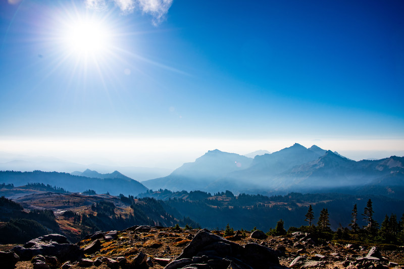 Hazy Cascade mountain range stretching to the horizon under a bright sun with alpine foreground